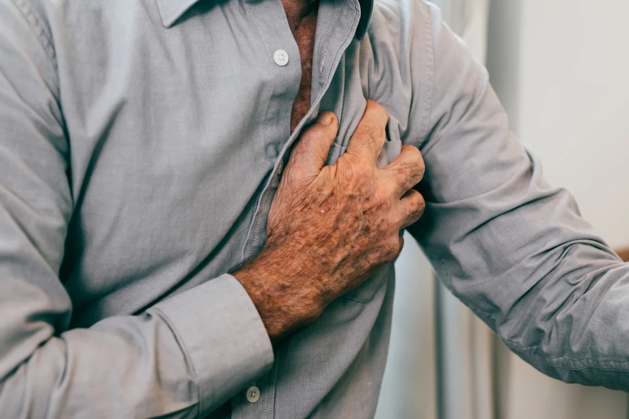 Senior Man with Chest Pain Holding His Chest